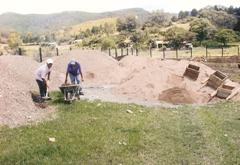 men haul sand to mix cement by hand