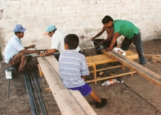 Men work on the beginning structure of the clinic