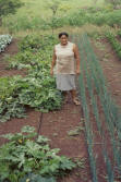 woman showing crops grown with donated seeds