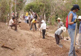 villagers & mission team work together in Moya